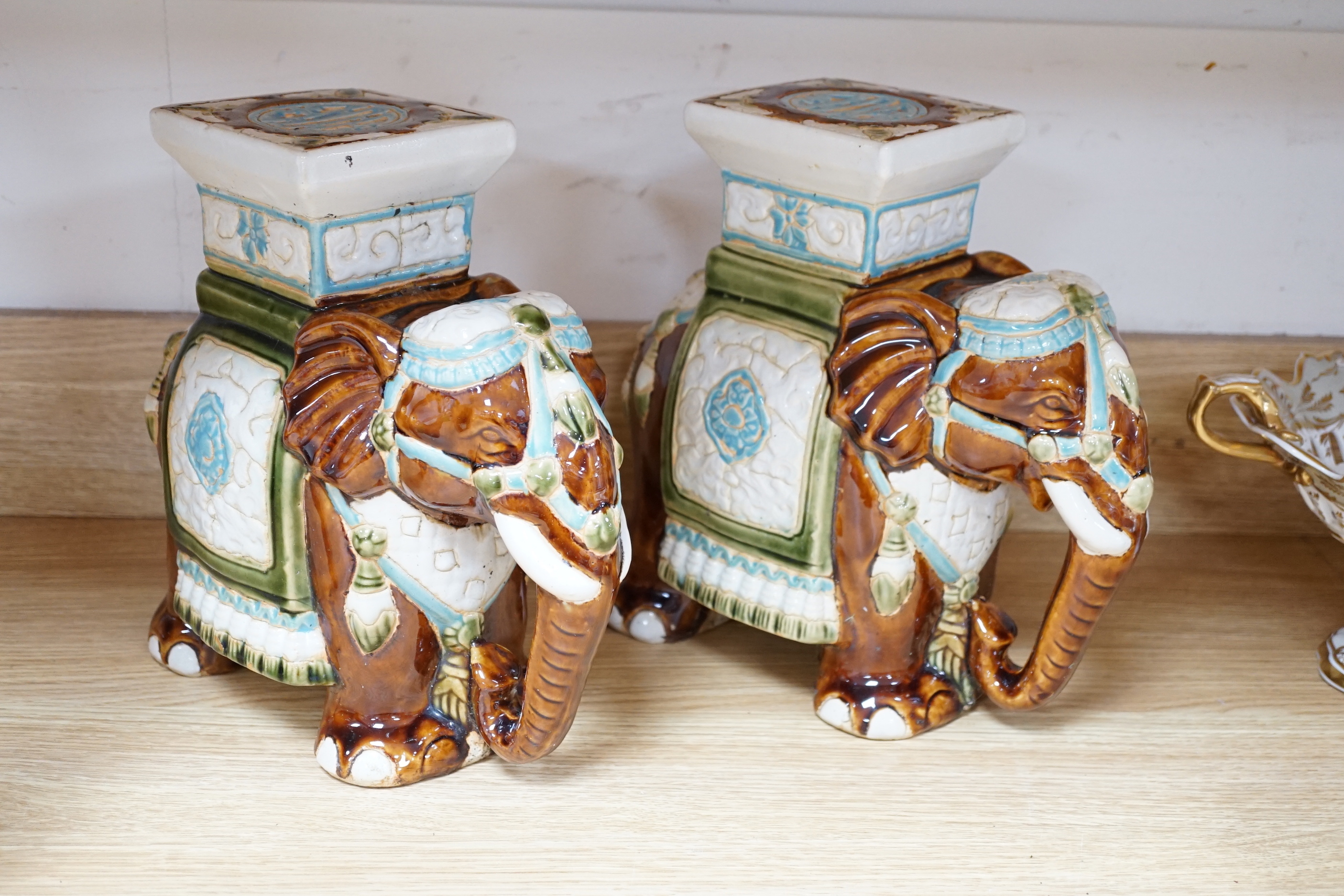 A pair and another elephant and howdah garden seats, largest 43cm